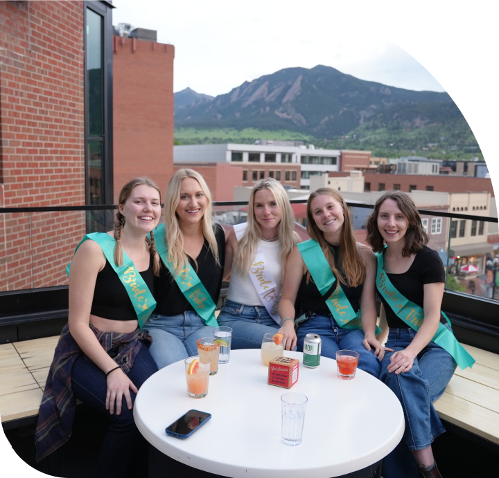 Bachelorette party relaxing together on a patio with mountain views