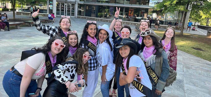 Bachelorette group posing with glasses and peace signs
