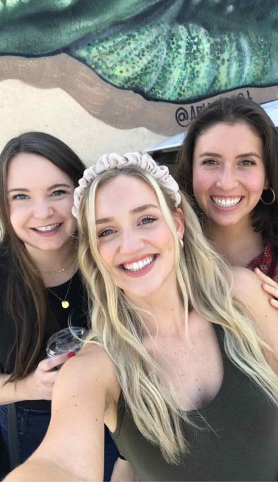 Bride and friends smiling together during a bachelorette scavenger hunt