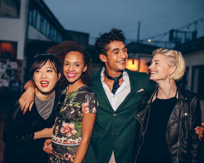 Group laughing during a city bar crawl challenge